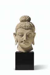 A STUCCO HEAD OF BUDDHA A STUCCO HEAD OF BUDDHA