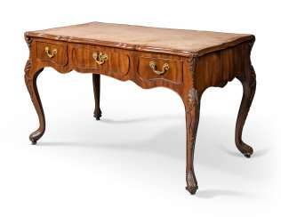 A GEORGE II CARVED MAHOGANY SERPENTINE WRITING-TABLE A GEORGE II CARVED MAHOGANY SERPENTINE WRITING-TABLE