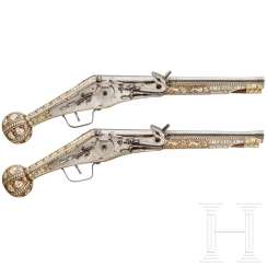 A pair of long wheel lock pistols, Peter Danner, Nuremberg, dated 1587, with later boned shafts A pair of long wheel lock pistols, Peter Danner, Nuremberg, dated 1587, with later boned shafts