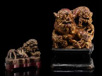 Two lion carvings in wood and stone stuff Two lion carvings in wood and stone stuff