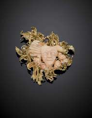 Yellow 9K gold and carved pink coral brooch accented with diamonds in all ct. 0.60 circa Yellow 9K gold and carved pink coral brooch accented with diamonds in all ct. 0.60 circa