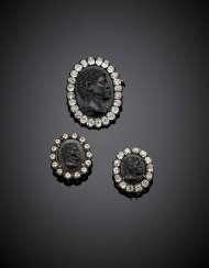 Two onyx and diamond silver and gold blackamoor cameo brooches and one similar reproduced with vitreous paste Two onyx and diamond silver and gold blackamoor cameo brooches and one similar reproduced with vitreous paste