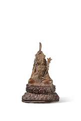 A GILT-BRONZE FIGURE OF PADMASAMBHAVA A GILT-BRONZE FIGURE OF PADMASAMBHAVA