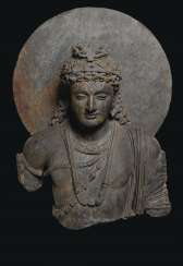 A MONUMENTAL GRAY SCHIST BUST OF A BODHISATTVA A MONUMENTAL GRAY SCHIST BUST OF A BODHISATTVA