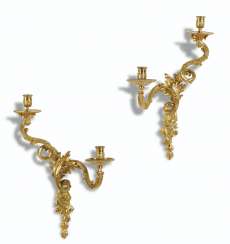 A PAIR OF REGENCE ORMOLU TWO-BRANCH WALL LIGHTS A PAIR OF REGENCE ORMOLU TWO-BRANCH WALL LIGHTS