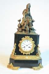 A clock with a bronze figure A clock with a bronze figure