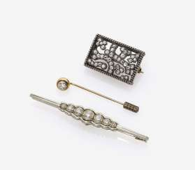 Two brooches and a tie pin with diamonds Two brooches and a tie pin with diamonds