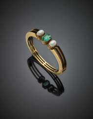 Yellow gold cuff bracelet with central octagonal ct. 2.45 circa emerald and two half pearl shoulders Yellow gold cuff bracelet with central octagonal ct. 2.45 circa emerald and two half pearl shoulders