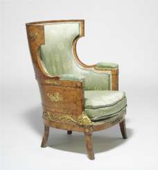 A Russian flamed birch wood and gilt bronze mounted “bergère à oreilles”, curved back and seat with cushion. Early 19th century. H. 100 cm. W. 72 cm. D. 74 cm. A Russian flamed birch wood and gilt bronze mounted “bergère à oreilles”, curved back and seat with cushion. Early 19th century. H. 100 cm. W. 72 cm. D. 74 cm.