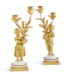 A PAIR OF LOUIS XVI ORMOLU AND WHITE MARBLE TWO-LIGHT CANDELABRA A PAIR OF LOUIS XVI ORMOLU AND WHITE MARBLE TWO-LIGHT CANDELABRA
