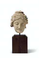 A STUCCO HEAD OF A BODHISATTVA A STUCCO HEAD OF A BODHISATTVA