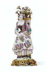 AN ORMOLU-MOUNTED MEISSEN PORCELAIN BOUQUETIERE FIGURE AN ORMOLU-MOUNTED MEISSEN PORCELAIN BOUQUETIERE FIGURE
