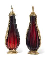 A PAIR OF GERMAN SILVER-GILT MOUNTED RUBY-GLASS BOTTLES A PAIR OF GERMAN SILVER-GILT MOUNTED RUBY-GLASS BOTTLES
