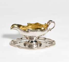 Silver gravy boat with gilt interior on fixed saucer style Rococo Silver gravy boat with gilt interior on fixed saucer style Rococo