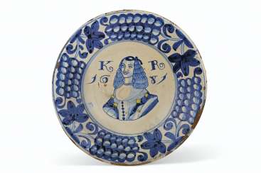 AN ENGLISH DELFT ROYAL PORTRAIT CHARGER OF CATHERINE OF BRAG... AN ENGLISH DELFT ROYAL PORTRAIT CHARGER OF CATHERINE OF BRAG...