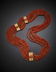 Eight strand orange coral faceted bead necklace with 9K chiseled gold clasp and spacers Eight strand orange coral faceted bead necklace with 9K chiseled gold clasp and spacers