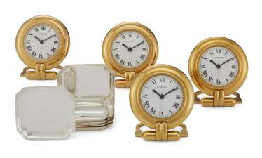 A SET OF FOUR GILT-METAL TABLE CLOCKS AND A SET OF EIGHT SILVER RECEIVING TRAYS A SET OF FOUR GILT-METAL TABLE CLOCKS AND A SET OF EIGHT SILVER RECEIVING TRAYS