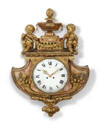 A LOUIS XVI TWO-TONE ORMOLU CARTEL CLOCK A LOUIS XVI TWO-TONE ORMOLU CARTEL CLOCK