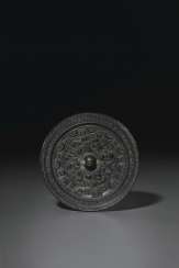 A SMALL BRONZE MIRROR A SMALL BRONZE MIRROR