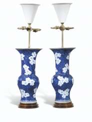 A PAIR OF CHINESE BLUE AND WHITE PRUNUS GU VASE LAMPS A PAIR OF CHINESE BLUE AND WHITE PRUNUS GU VASE LAMPS