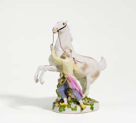 Porcelain figurine of oriental with rearing horse Porcelain figurine of oriental with rearing horse
