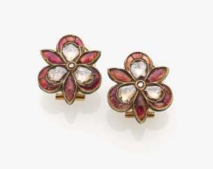 A pair of ear clips with diamond roses and rubies A pair of ear clips with diamond roses and rubies