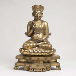 Excellent fire-gilded repoussé technology-figure of a seated Lama on a pedestal Excellent fire-gilded repoussé technology-figure of a seated Lama on a pedestal