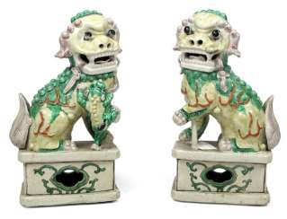 Two yellow and green glazed Fo dogs, made of porcelain Two yellow and green glazed Fo dogs, made of porcelain