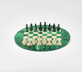 Malachite chess on a round table top Malachite chess on a round table top