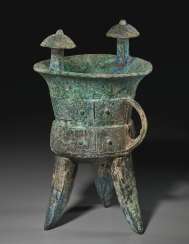 A BRONZE RITUAL TRIPOD WINE VESSEL, JIA A BRONZE RITUAL TRIPOD WINE VESSEL, JIA