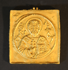 A gold amulet with two eyes and chased St. Nicholas with inscription A gold amulet with two eyes and chased St. Nicholas with inscription