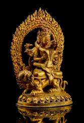 Gilded Bronze of Manjushri on a lion over a Lotus sitting Gilded Bronze of Manjushri on a lion over a Lotus sitting